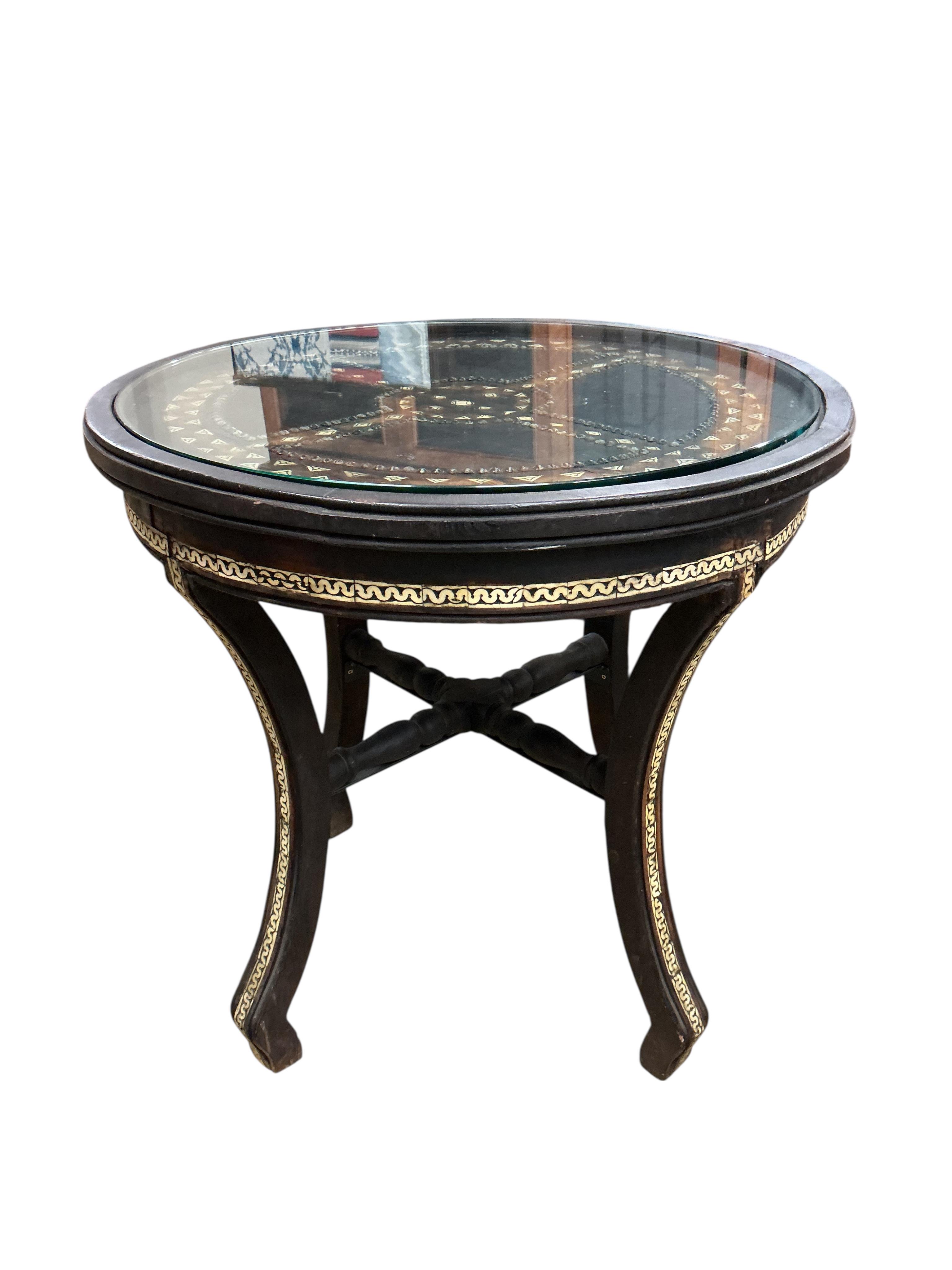 A Moroccan circular studded cedar glass top bistro table, diameter 80cm, height 76cm together with two matching chairs
